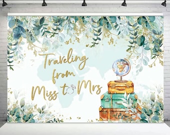 May include: A light blue and green watercolor background with gold glitter accents. The text "Traveling from Miss to Mrs" is written in gold glitter font. A globe and stack of suitcases are in the center of the image.
