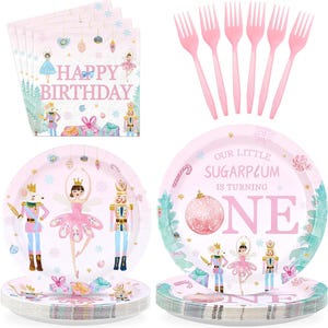 May include: A collection of party supplies with a ballet theme. Includes pink paper plates, napkins, and forks. The plates and napkins feature illustrations of ballerinas, nutcrackers, and the text "Happy Birthday" and "Our Little Sugarplum is turning ONE."