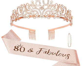 May include: Rose gold-colored tiara with the number 80 and sparkling rhinestones. A matching sash reads "80 & Fabulous" in brown script. A pearl-adorned pin and hair combs complete the birthday set.