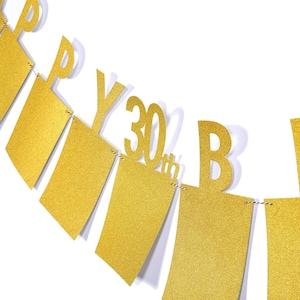 May include: Gold glitter Happy 30th Birthday banner with white letters and gold glitter flags.