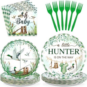 May include: A collection of hunting-themed party supplies, including plates, napkins, and green plastic forks. The plates feature a duck and rifle design, with text that reads "a little HUNTER is on the way". The napkins say "Oh Baby".