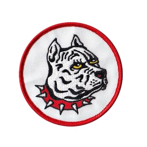May include: White embroidered patch of a pit bull with a red studded collar on a white background with a red circular border.