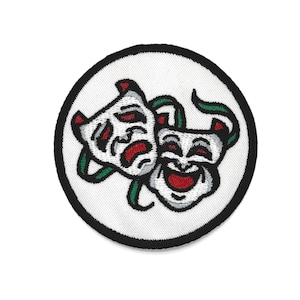 May include: Embroidered patch featuring the classic comedy and tragedy theater masks. The masks are white with red accents, green vines, and a black border. The patch is circular and suitable for clothing or accessories.