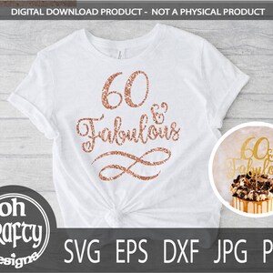 May include: A white t-shirt with the text "60 & Fabulous" in rose gold glitter. The text is in a cursive font and is surrounded by a rose gold glitter swirl. The t-shirt is on a wooden background.