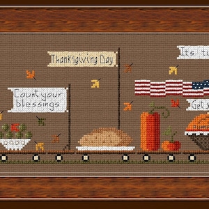 Op de afbeelding: Een kruissteekpatroon met een Thanksgiving-trein met verschillende wagons. De wagons zijn versierd met herfstbladeren, pompoenen en kalkoenen. De trein trekt een wagon met een taart erop. De tekst op de wagons luidt "Thanksgiving Day", "Gather here with grateful hearts", "Count your blessings" en "Get your pie on".