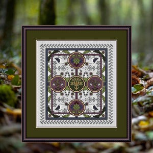 May include: Framed cross-stitch artwork featuring a symmetrical design with four circular motifs in purple, green, and gold. The artwork includes stylized birds and floral elements, framed in a dark green mat and a brown frame.