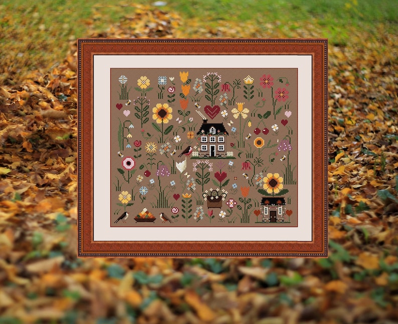 May include: A framed cross-stitch pattern featuring a brown house with a white door and windows, surrounded by colorful flowers, birds, and bees on a brown background.