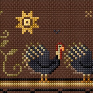 May include: Cross-stitch pattern featuring two turkeys with brown and black feathers, a yellow sun, and two orange pumpkins with green vines. The background is brown.