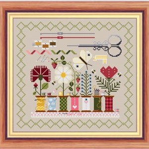 May include: A cross-stitch pattern featuring a colorful arrangement of sewing supplies, including spools of thread, scissors, needles, and a butterfly. The design is set against a background of green and white squares.