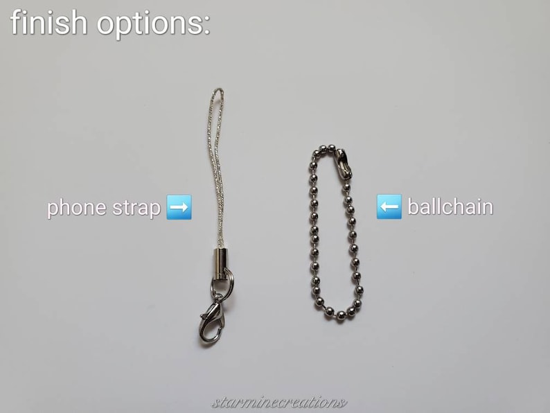 May include: Image showing two finish options: a silver phone strap with a lobster clasp and a silver ball chain. Text indicates the options are "phone strap" and "ballchain". The text "finish options:" is at the top.