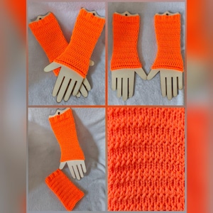 May include: Bright orange, fingerless arm warmers. The knitted arm warmers are displayed on wooden hand-shaped forms. The close-up shows the texture of the knitted fabric. The arm warmers are a vibrant, solid color.