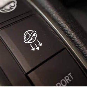 May include: A white icon of a soccer ball with arrows pointing down, on a black button labeled "Sport".
