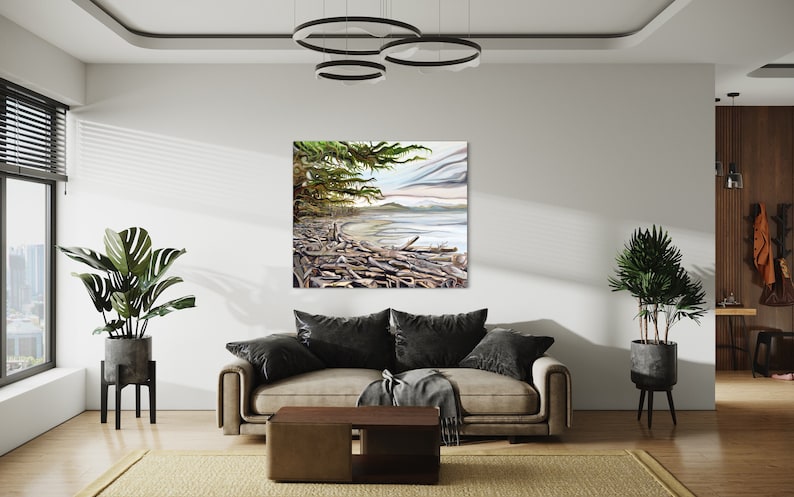 May include: A square canvas art print depicting a coastal scene with driftwood, a sandy beach, and a cloudy sky. The artwork features a color palette of greens, blues, and browns, and is displayed in a modern living room setting.