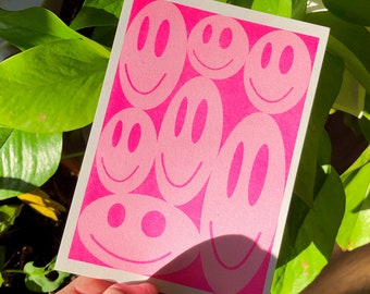 risograph postcard of a smiley composition (fluor pink)