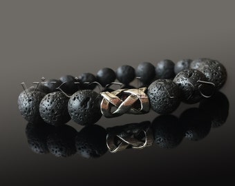 May include: Black lava rock beaded bracelet with a silver Celtic knot charm.