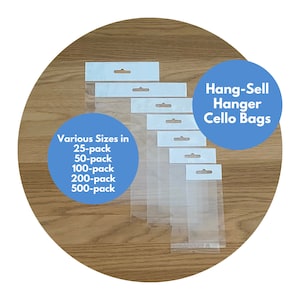 May include: Assortment of clear plastic hang-sell cello bags with a white header and a hole for hanging. The bags are displayed on a wooden surface. Various Sizes in 25-pack, 50-pack, 100-pack, 200-pack, 500-pack. Hang-Sell Hanger Cello Bags.
