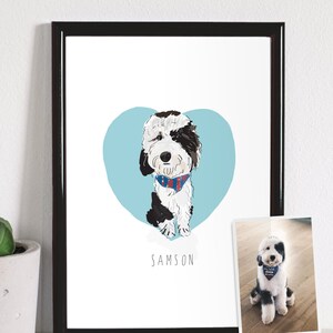 May include: A framed art print featuring a cartoon illustration of a dog named Samson. The dog is black and white with a blue and red patterned bandana, set against a light blue heart. A smaller photo of the dog is also present.