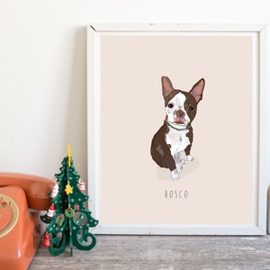 May include: Framed art print featuring a Boston Terrier dog illustration. The dog is brown and white, with the name "Bosco" below. The artwork is set against a pale pink background, in a white frame. A vintage orange telephone and a green Christmas tree are in the foreground.