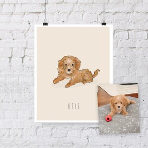 May include: A print featuring a light brown dog illustration, lying down on a cream background. The dog's name, "Otis," is written below. A smaller photo of the dog is included, lying on a gray patterned dog bed with a red toy.