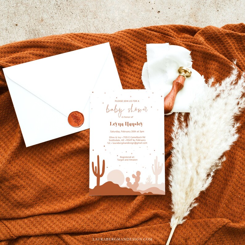 May include: A baby shower invitation with a desert theme. The invitation features a tan background with a silhouette of a desert landscape with cacti and a sunset. The text on the invitation reads "Please join us for a baby shower in honor of Leyna Hansley. Saturday, February 25th at 3pm. Olive & Ivy - 7135 E Camelback Rd Scottsdale, AZ. RSVP by February 1st - laurabergmandesign@gmail.com. Registered at Target and Amazon."