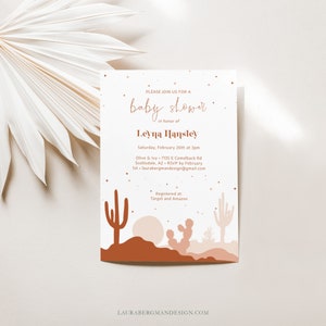 May include: A baby shower invitation with a desert theme. The invitation features a pink and brown cactus illustration with a starry night sky. The text reads "Please join us for a baby shower in honor of Leyna Hansley. Saturday, February 26th at 3pm. Olive & Ivy, 7135 E Camelback Rd, Scottsdale, AZ. RSVP by February 1st. laurabergmandesign@gmail.com. Registered at: Target and Amazon."