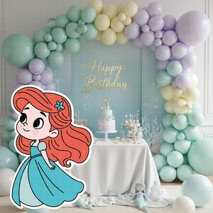 May include: A cartoon illustration of a mermaid in a blue dress with red hair and a blue flower. The background features a birthday party scene with a cake, balloons, and the words "Happy Birthday".
