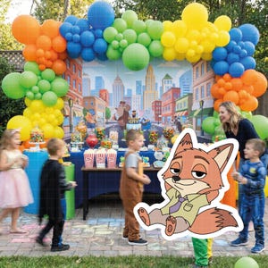 May include: A colorful party scene with a balloon arch in rainbow colors. A table is set with treats and a cityscape backdrop. Children are present, and a cartoon fox cutout is in the foreground. The theme appears to be a children's party.