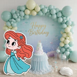 May include: A birthday party scene with a cartoon illustration of a mermaid in a blue dress. The background features a balloon arch in shades of blue and yellow, a cake, and the words "Happy Birthday".