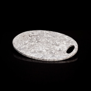 May include: A gray oval-shaped serving tray with a handle. The tray has a speckled pattern and is made of marble.