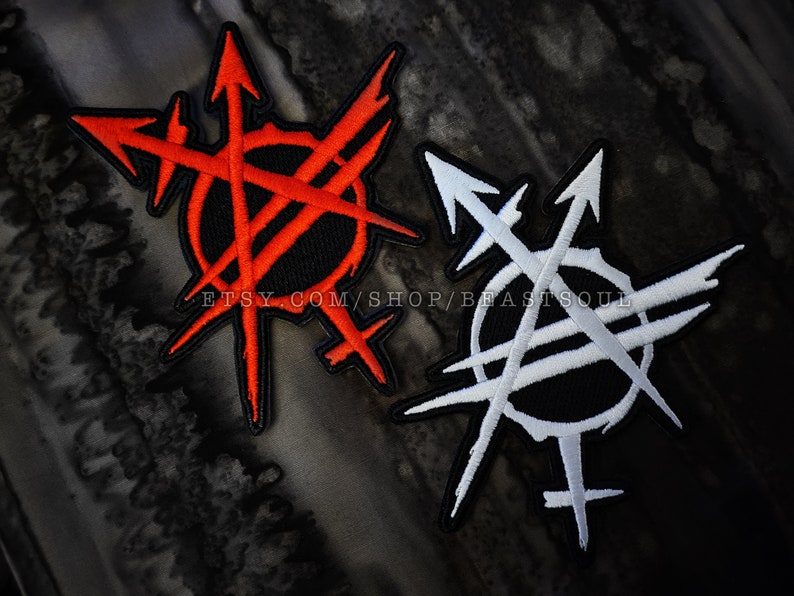 May include: Two embroidered patches with a black background and white and red stitching. The patches feature a circle with a cross through it and arrows pointing in different directions. The text "etsy.com/shop/beastsoul" is visible on the bottom of the patches.