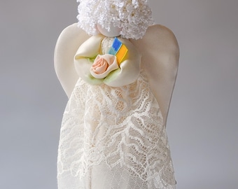 Guardian Angel Interior Doll with curls: gives a flower with Ukrainian flag blue and yellow