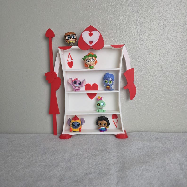 May include: A white and red decorative shelf in the shape of a playing card, with the Ace of Hearts design. The shelf is filled with small character figurines. The shelf is approximately 18 inches tall.