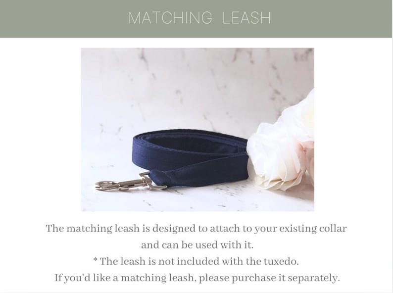 May include: A navy blue fabric dog leash featuring a silver-toned metal swivel snap hook. The leash is coiled and displayed alongside a white floral accent. The text MATCHING LEASH is visible at the top, with additional text below the leash.