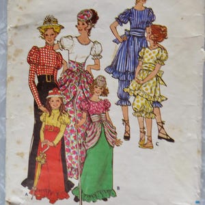 May include: Vintage Butterick sewing pattern envelope featuring illustrations of women and girls in various dresses and outfits. The envelope is off-white with the brand name and size information. The pattern number is 5980.