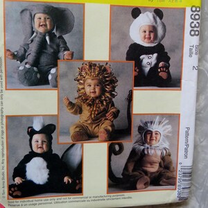 May include: A McCall's Costumes sewing pattern envelope, number 8938, featuring The Arma Collection by Tom Arma. The yellow package displays five infant costumes: an elephant, a panda, a lion, a skunk, and a monkey, each worn by a baby.