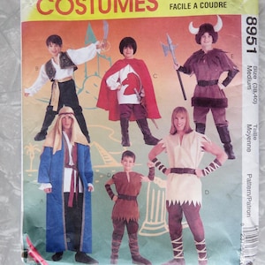 May include: McCall's Costumes pattern featuring various historical and fantasy outfits. The cover displays illustrations of children and adults in costumes, including a Viking, a knight, and an Arabian sheik. The text "EASY TO SEW" is visible.
