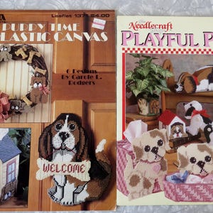 May include: Two vintage craft pattern books. One titled "Puppy Time in Plastic Canvas" features a wreath and dog designs. The other, "Playful Pups," showcases various puppy-themed projects. Both books offer plastic canvas patterns.