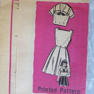 May include: Vintage printed sewing pattern featuring a sailor-style dress and top design. The pattern includes illustrations of the garments and a small figure wearing the outfit. The text "Printed Pattern" and "9040 - SIZE 12" are visible.