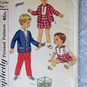 May include: Vintage Simplicity sewing pattern for toddler boys' clothing. The pattern includes a red and white plaid shirt and shorts, a blue cardigan with red and white trim, and a white shirt with a red and white plaid bib. The pattern number is 3288 and the size is 1.