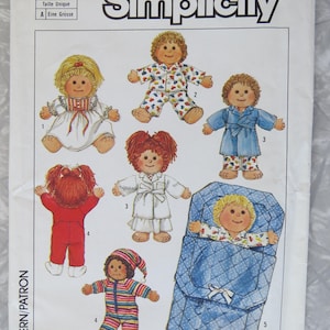 May include: Simplicity sewing pattern 6968 featuring doll designs in various sleepwear. The pattern includes dolls in pajamas, robes, and a sleeping bag. The dolls have different hairstyles and outfits.