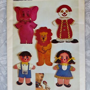 May include: Simplicity pattern 9739 featuring felt animal and clown figures. The figures include an elephant, lion, clown, boy, and girl. The pattern is for a transfer pattern.