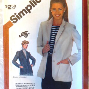 May include: A Simplicity 5926 sewing pattern envelope for a Jiffy blazer. The cover features a light-colored blazer with two front patch pockets and two buttons, worn over a dark skirt and a black and white striped top. Text includes size U.