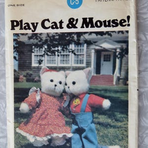 May include: A vintage sewing pattern for making a play cat and mouse. The pattern is from Butterick and is number 5666. The pattern shows two white plush toys, one dressed in a red and white dress and the other in a blue overall and red shirt.