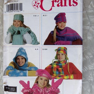 May include: A Simplicity Crafts sewing pattern envelope, number 7005, featuring illustrations of various winter accessories including hats, scarves, and mittens in different colors and patterns like stripes, plaid, and floral prints, with the text Simplicity Crafts.