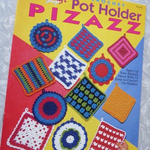 May include: A book cover titled "Pot Holder PIZAZZ" featuring various colorful crochet pot holders. The pot holders are square and round, with different patterns and colors, including red, blue, orange, and white. The cover has a yellow background with red and blue accents.