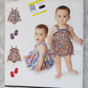 May include: A Simplicity sewing pattern featuring baby rompers and accessories. The pattern includes various romper designs with colorful patterns and matching shoes. The pattern is labeled with the Cynthia Rowley brand and includes sizing information.