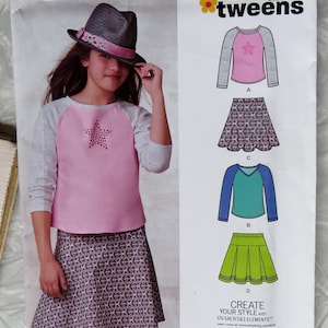 May include: A sewing pattern for tweens, featuring a pink and gray raglan sleeve top with a star design, and a patterned skirt. The pattern includes various top and skirt styles. The package has the text "NEW LOOK" and "CREATE YOUR STYLE".