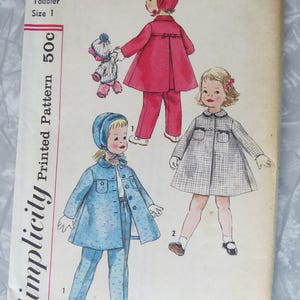 May include: A vintage Simplicity toddler size 1 sewing pattern envelope 2741. The cover features illustrations of children wearing a coat, pants, and bonnet set in red and blue, plus a plaid coat. The text includes Simplicity, 2741, and Toddler Size 1.