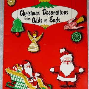 May include: A vintage Christmas-themed book cover with a red background. The cover features illustrations of Santa Claus, angels, and Christmas ornaments. The title reads "Christmas Decorations from Odds n' Ends."