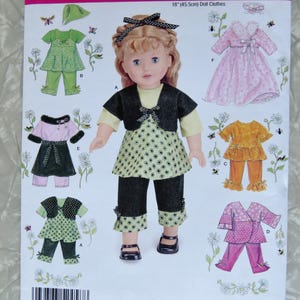 May include: A Simplicity 2458 sewing pattern envelope for 18-inch doll clothes. The front features a blonde doll wearing a green patterned top, black pants, and a black bolero jacket. Illustrations show various outfit options including dresses and sets.